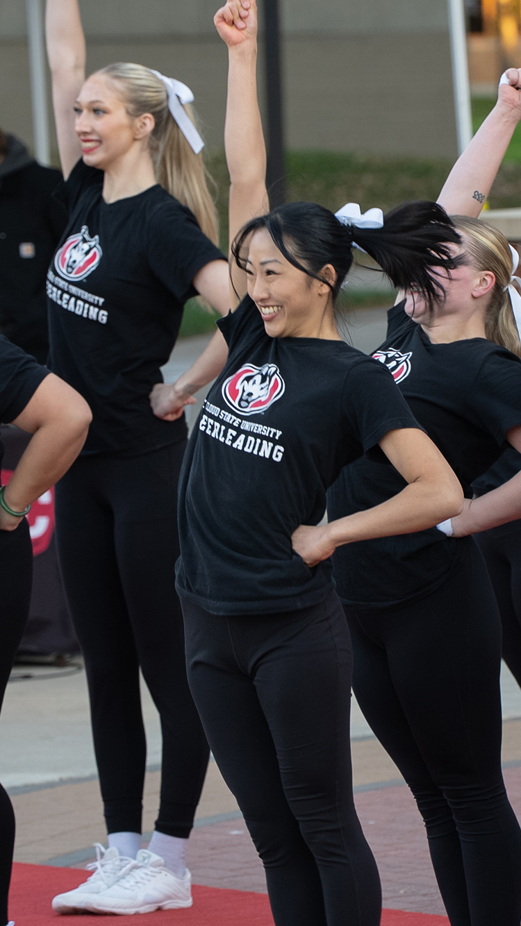 SCSU cheerleaders perform a cheer on Husky Plaza