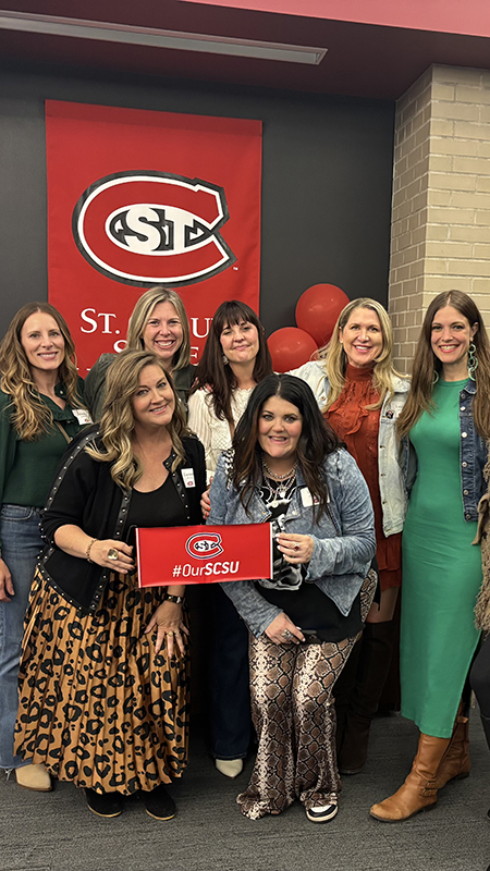 A group of alumnae gather for a photo at a class reunion