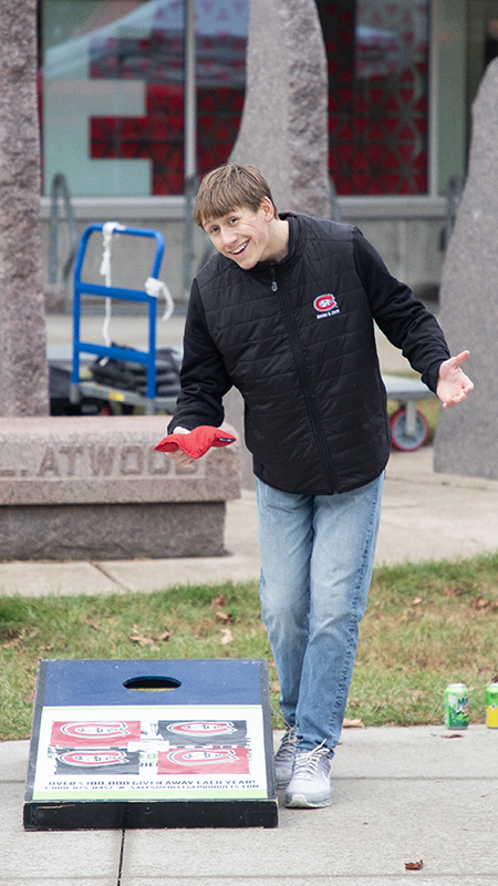 Two SCSU students play cornhole on Husky Plaza