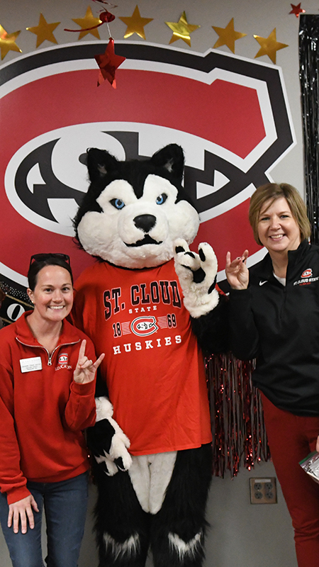 SCSU staff pose for a picture with Blizzard with their decorated office