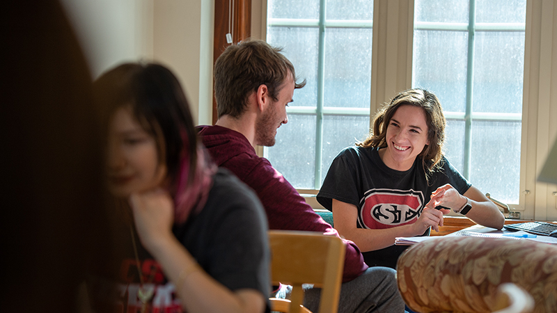 Honors students gathered in a Lawrence Hall lounge space