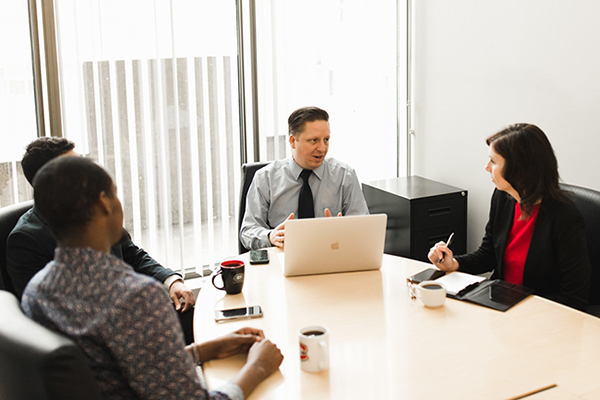 Faculty speaking in a conference room