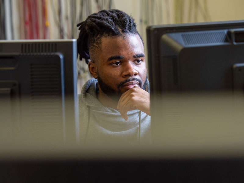 Student looking at two monitors