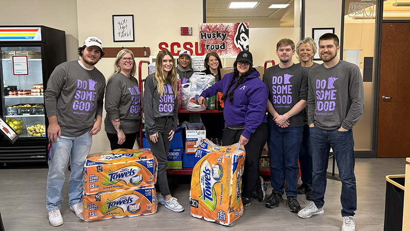 Affinity Plus employees with items donated to the Huskies Food Pantry