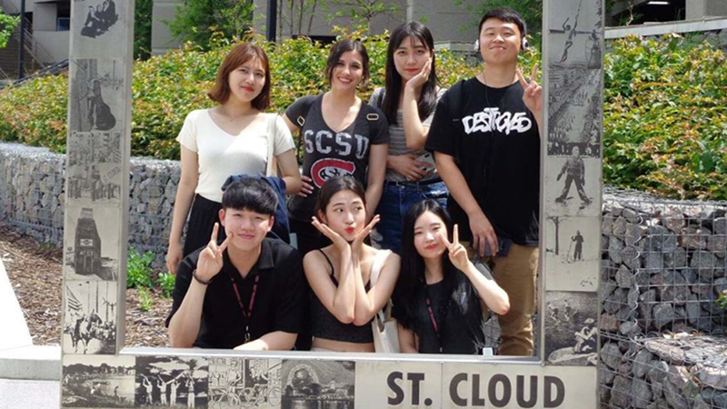 Group of international students posed for photo in downtown St. Cloud
