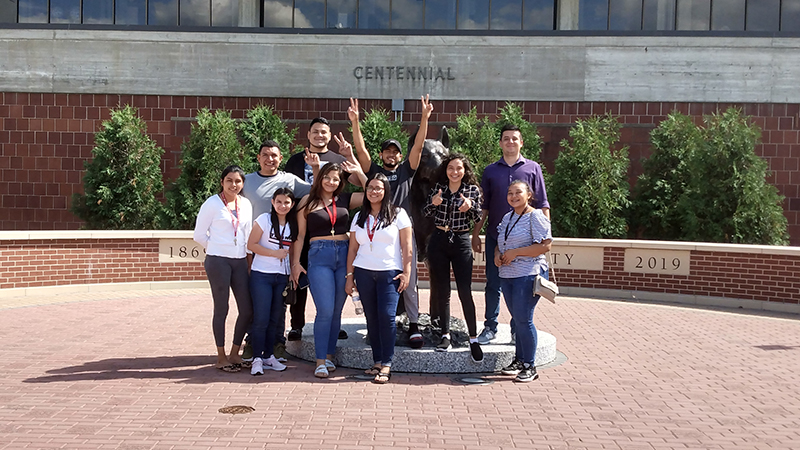 Group of international students posed for photo on Husky Plaza