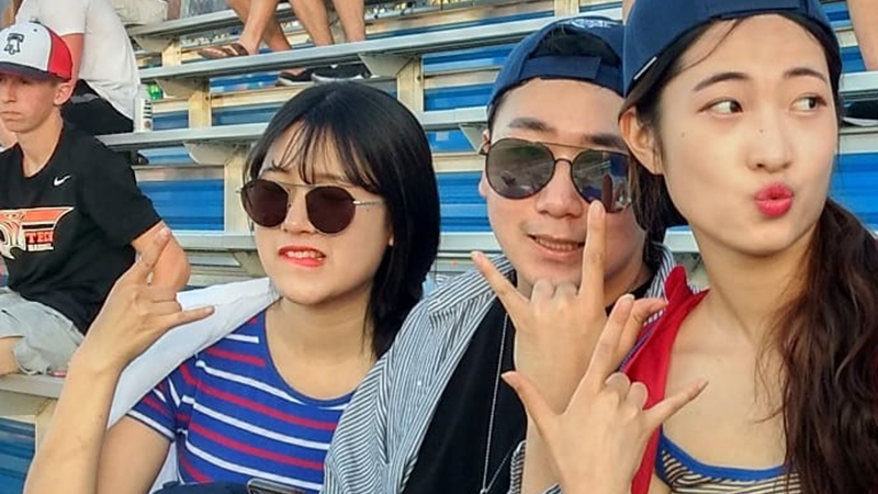 Three international students enjoying a St. Cloud Rox baseball game
