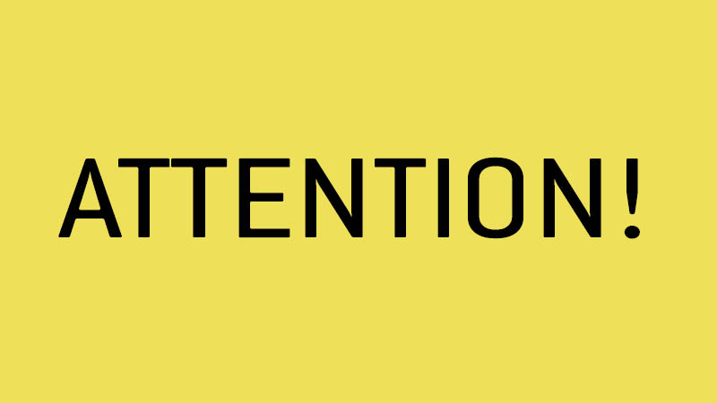 Bright yellow graphic with "attention" in large type