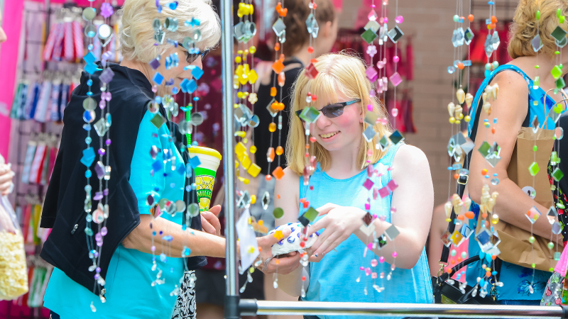 Young girl looking at sun catchers