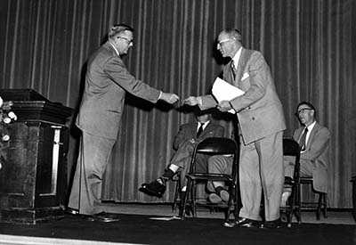 Wilbur Holes (right) accepts the keys to Kiehle, 1953