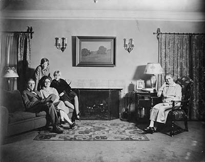 Claude Lewis family in living room, 1930s