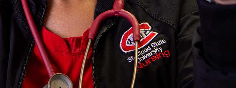 A close up of a St. Cloud State student's nursing scrubs and stethoscope