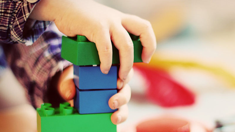 Child hand with lego