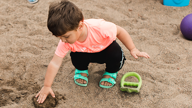 Kid playing in sandbox
