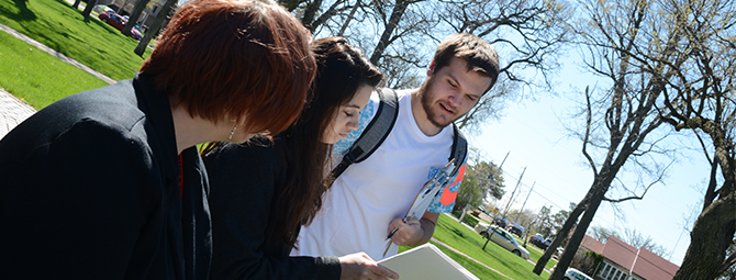 St. Cloud State Philosophy students participate in a class outside on a beautiful spring day.