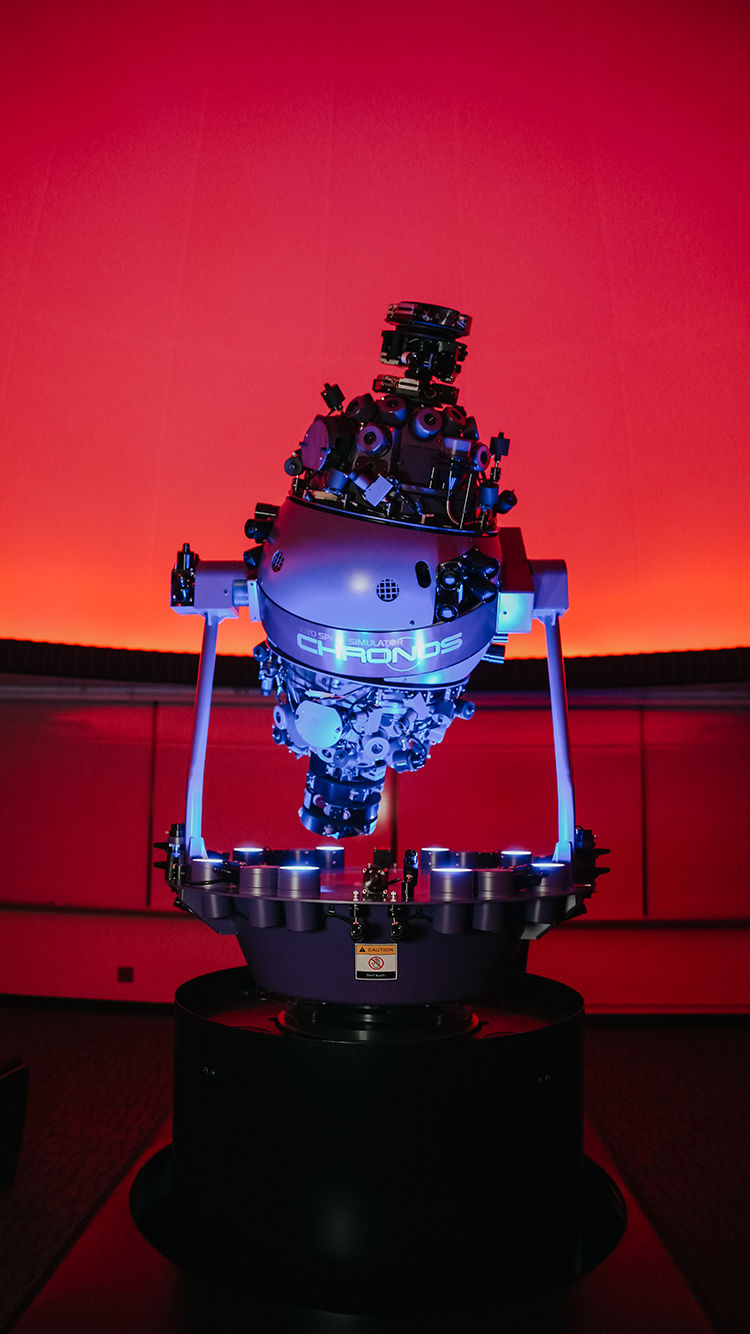 Starball projector brightly lit up with striking red sky on planetarium dome