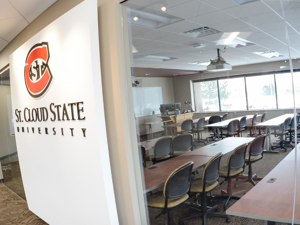 a view of a classroom from the hallway looking through a glass window