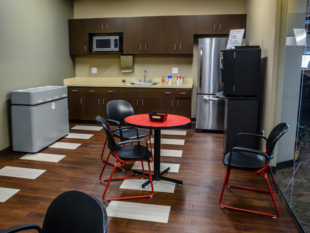 a view of the kitchen area showing a fridge and microwave