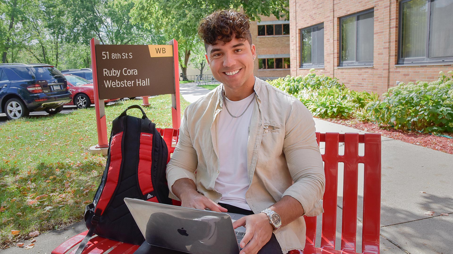 Student on bench with computer