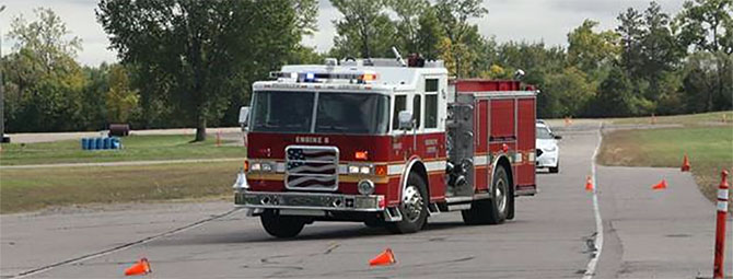 PDCM instructor talks to a fire truck driver