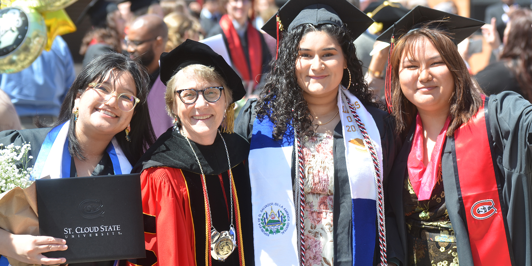 President Wacker with graduates outside