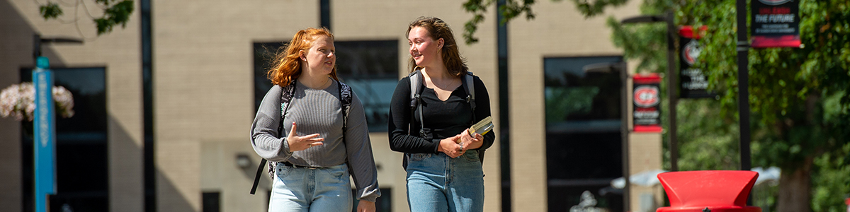 Two students walking on campus