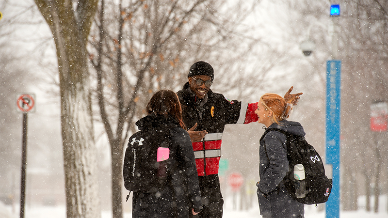 St. Cloud State University patrol officer talking with St. Cloud State students