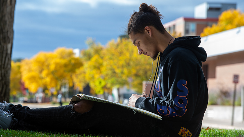 Student drawing outside