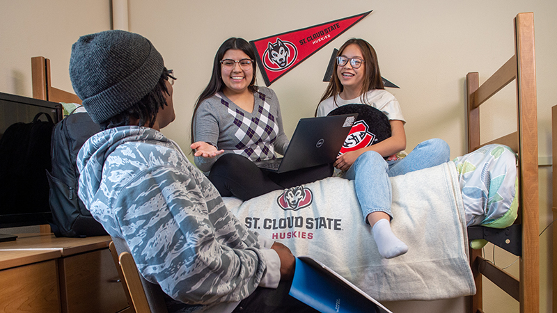 Three students in dorm room