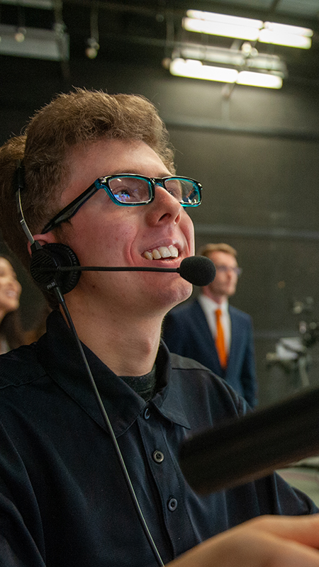 Student operating TV studio camera