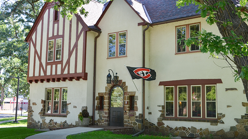Lewis House, a tudor-style home with SCSU flag