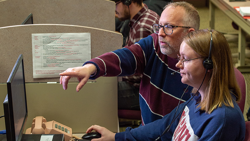 Professor working with student caller