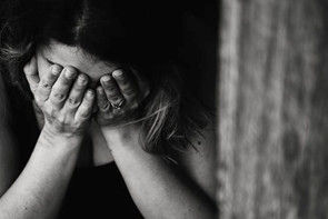 Person with their head in their hands
