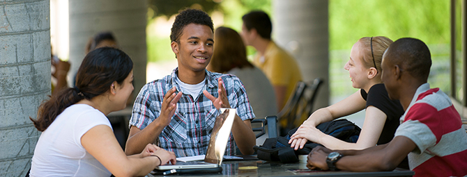 St. Cloud State students work on a group project outside.