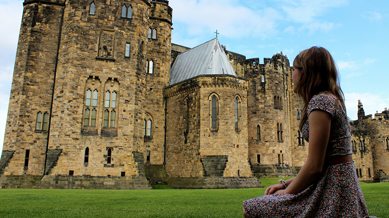 Girl looking at Alnwick Castle