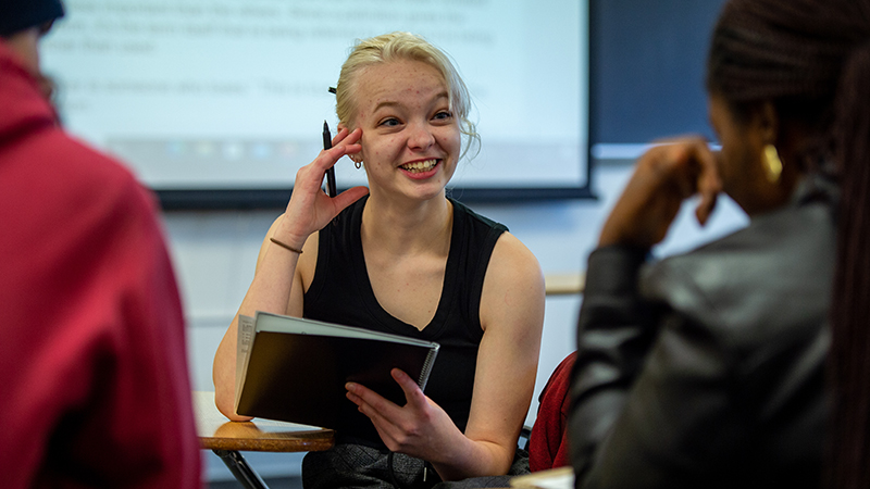 Alert and smiling student in critical reasoning class