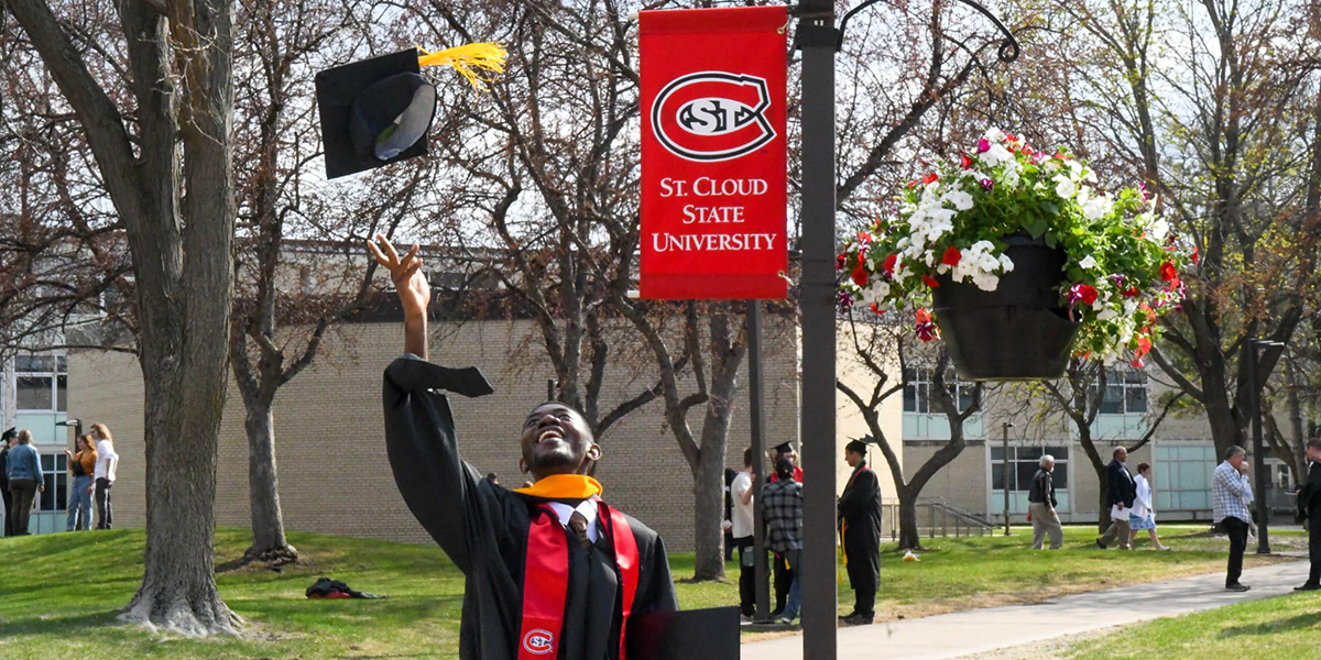 Grad throwing cap into air