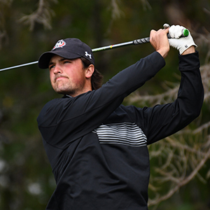 A member of the SCSU Huskies men's golf team completes a swing