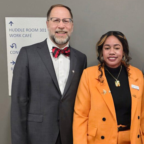 President Gregory Tomso smiles next to Javelia Morrison-Galimore
