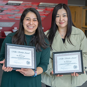 Professors Luna and Choi smile outside of the Miller Scholars reception