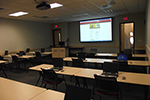 Meeting space set for training with laptops.